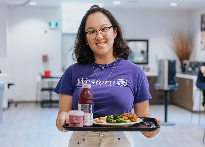 Student carrying a tray of food